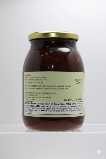 Jar of pasta sauce with a gold lid on a white background